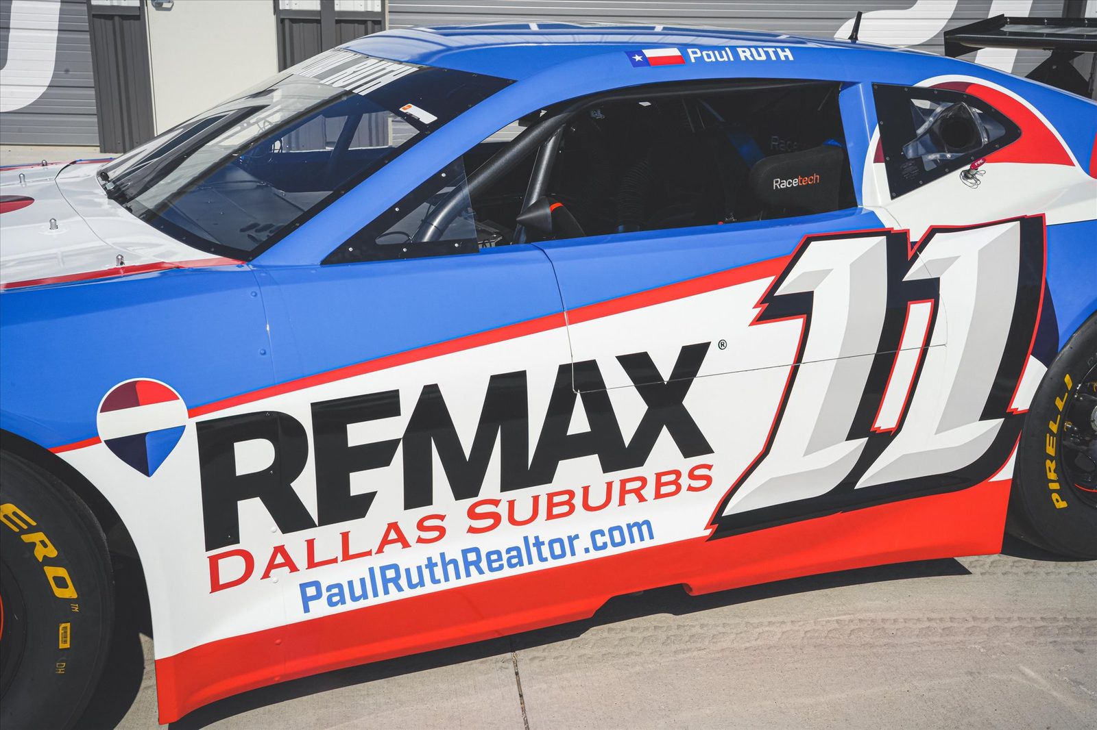 A RE/MAX race car, number 11, with Paul Ruth's name on the windshield