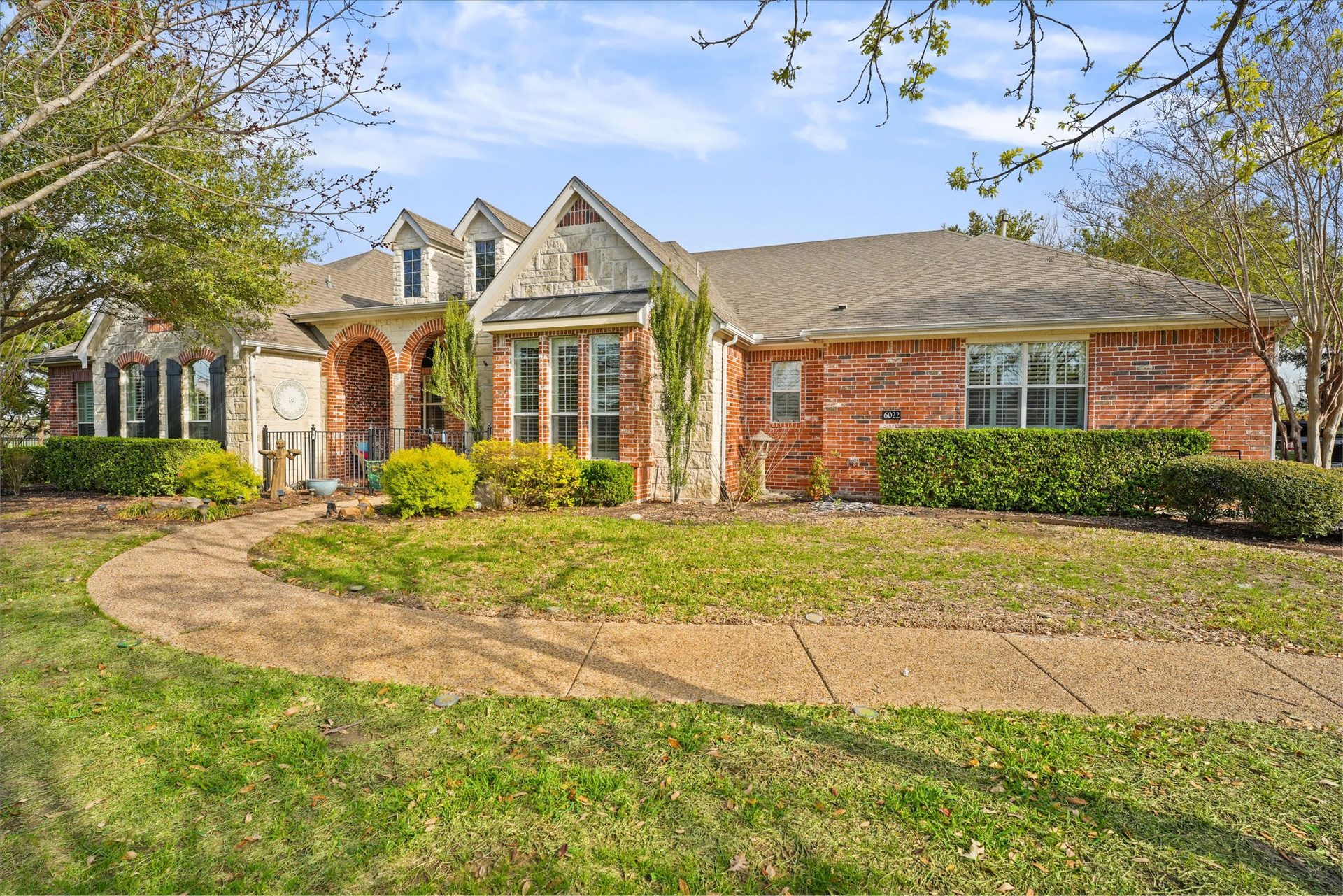 A brick home with a curving front walk, one of Paul Ruth's listings